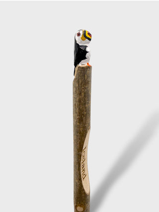 Wooden pencil with a penguin eraser on a white background