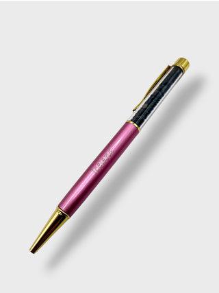 Pen with pink body, black accents, and gold accents on a white background