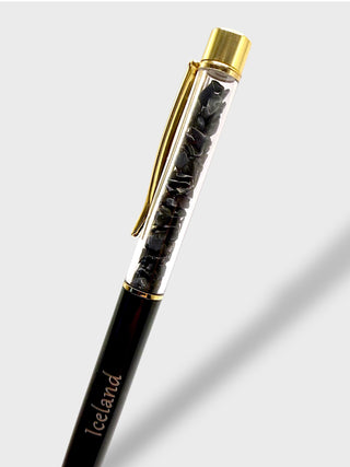 Pen with gold accents and clear cap on a light gray background