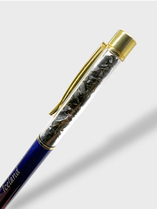 Pen with gold clip and clear cartridge on a white background
