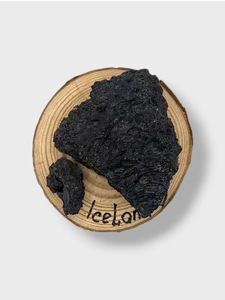 Black soap块 on a wooden board with 'Iceland' branding.