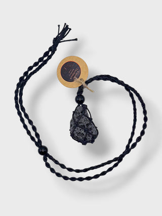Black cord necklace with a stone pendant on a white background