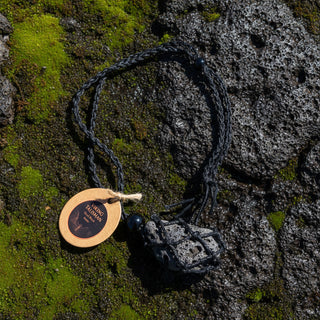 Necklace with a textured pendant and wooden tag on a white background