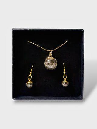 Jewelry set with necklace and earrings in a black box on a white background