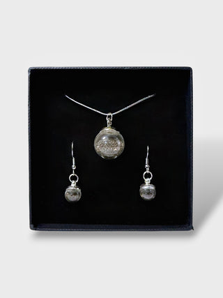 Jewelry set with necklace and earrings on a black display box
