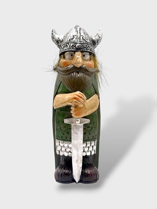 Hand-painted polyresin Icelandic Viking figurine with silver helmet, green cloak, long beard, and both hands resting on a large sword, 18 cm (7.09 in) tall.