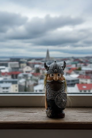 A small Viking figurine with a horned helmet, long brown beard, and textured armor