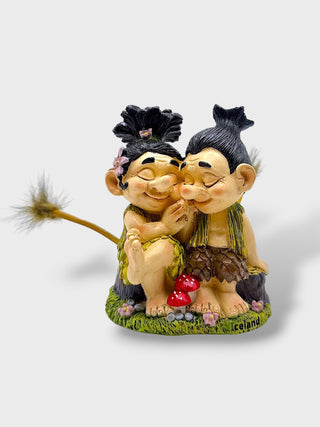 Hand-painted polyresin Icelandic troll couple sitting together with smiling faces, flowers, and playful tails, inspired by Icelandic folklore, 12 cm (4.72 in) tall.

