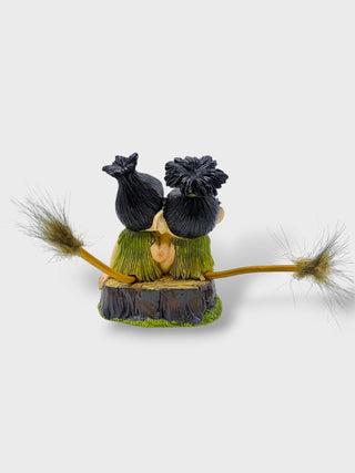 Hand-painted polyresin Icelandic troll couple sitting together with smiling faces, flowers, and playful tails, inspired by Icelandic folklore, 12 cm (4.72 in) tall.

