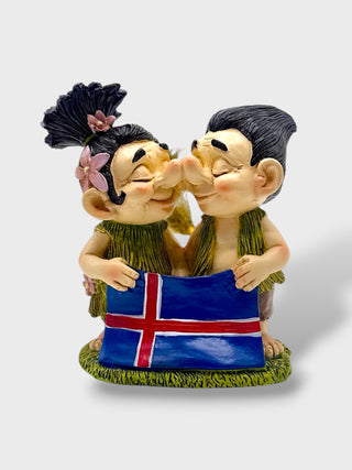 Hand-painted polyresin Icelandic troll couple kissing while holding the Icelandic flag, wearing traditional-style outfits, 12 cm (4.72 in) tall.
