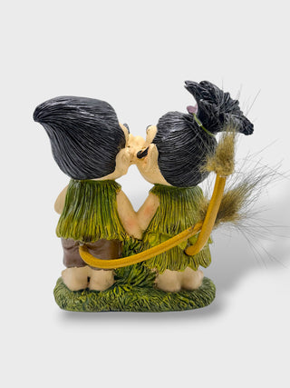 Hand-painted polyresin Icelandic troll couple kissing while holding the Icelandic flag, wearing traditional-style outfits, 12 cm (4.72 in) tall.
