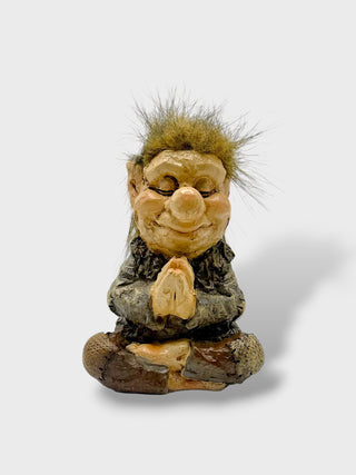 Hand-painted polyresin meditating Icelandic troll figurine sitting cross-legged with folded hands, closed eyes, fluffy hair, and a peaceful smile, 11 cm (4.33 in) tall.
