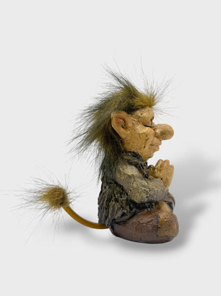 Hand-painted polyresin meditating Icelandic troll figurine sitting cross-legged with folded hands, closed eyes, fluffy hair, and a peaceful smile, 11 cm (4.33 in) tall.

