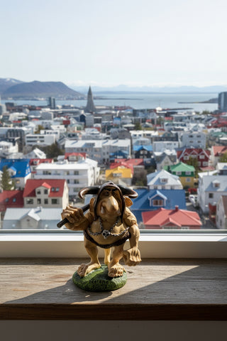 A fantasy figurine of a muscular, snout-faced creature with large horns, wearing a skull-and-chain necklace and a brown loincloth, standing on a green base labeled 'Iceland' and holding a dark club.