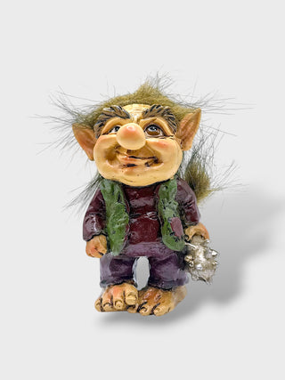 Hand-painted polyresin Icelandic troll figurine holding a sea shell, wearing a purple outfit with a green vest, fluffy hair, and a smiling face, 9 cm (3.54 in) tall.
