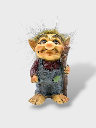 Hand-painted polyresin Icelandic troll figurine holding a walking stick, wearing grey overalls and a burgundy shirt with fluffy hair, 9 cm (3.54 in) tall.
