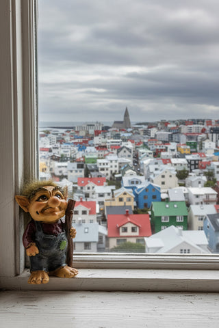 Hand-painted polyresin Icelandic troll figurine holding a walking stick, wearing grey overalls and a burgundy shirt with fluffy hair, 9 cm (3.54 in) tall.
