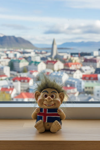 Hand-painted polyresin Icelandic troll figurine holding the Icelandic flag with a smiling face and fluffy hair, 7 cm (2.76 in) tall.
