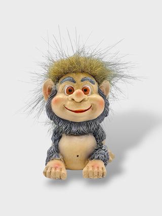 Hand-painted polyresin Icelandic troll figurine with a smiling face, shaggy grey outfit, fluffy hair, and expressive eyes, 7 cm (2.76 in) tall.
