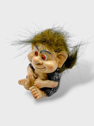 Hand-painted polyresin Icelandic troll figurine with a smiling face, expressive eyes, dark clothing, and playful hair, 7 cm (2.76 in) tall.
