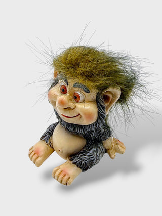 Hand-painted polyresin Icelandic troll figurine with a smiling face, shaggy grey outfit, fluffy hair, and expressive eyes, 7 cm (2.76 in) tall.

