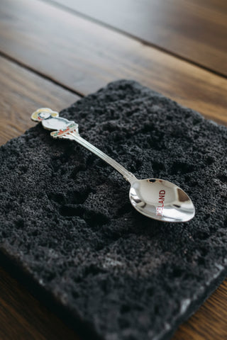 Iceland souvenir spoon with colorful puffin wearing yellow hat and Iceland engraving