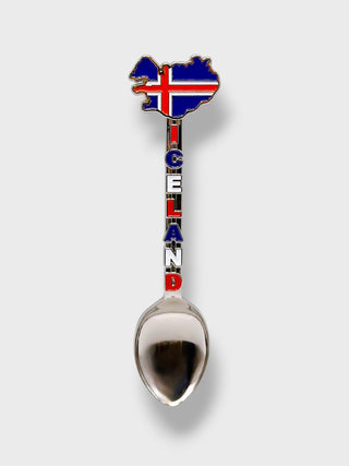 A novelty spoon featuring an enamel map of Iceland on the spoon handle, with the word 'ICELAND' spelled vertically in Icelandic flag colors, and a polished silver-colored metal spoon bowl.