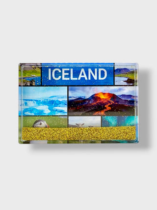 A rectangular acrylic magnet featuring a collage of Iceland landscapes, including glaciers, an active volcano, and a golden beach, with a blue banner at the top reading 'ICELAND' in white capital letters.