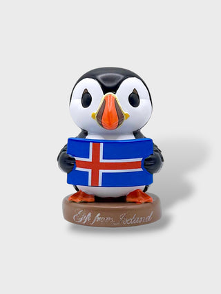 Cute Iceland puffin figurine holding the Icelandic flag on a Gift from Iceland base

