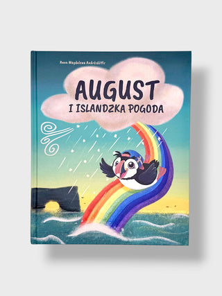 A hardcover children's book titled 'AUGUST I ISLANDZKA PogODA' by Anna Miodowska-Jakubiń, featuring a colorful illustration of a puffin sliding down a rainbow in the rain, set against a light gray background.