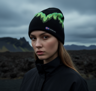 Person wearing a black beanie with green patterns against a dark, mountainous landscape