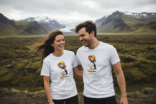 Two people wearing white t-shirts with lion and lioness graphics in a mountainous landscape.